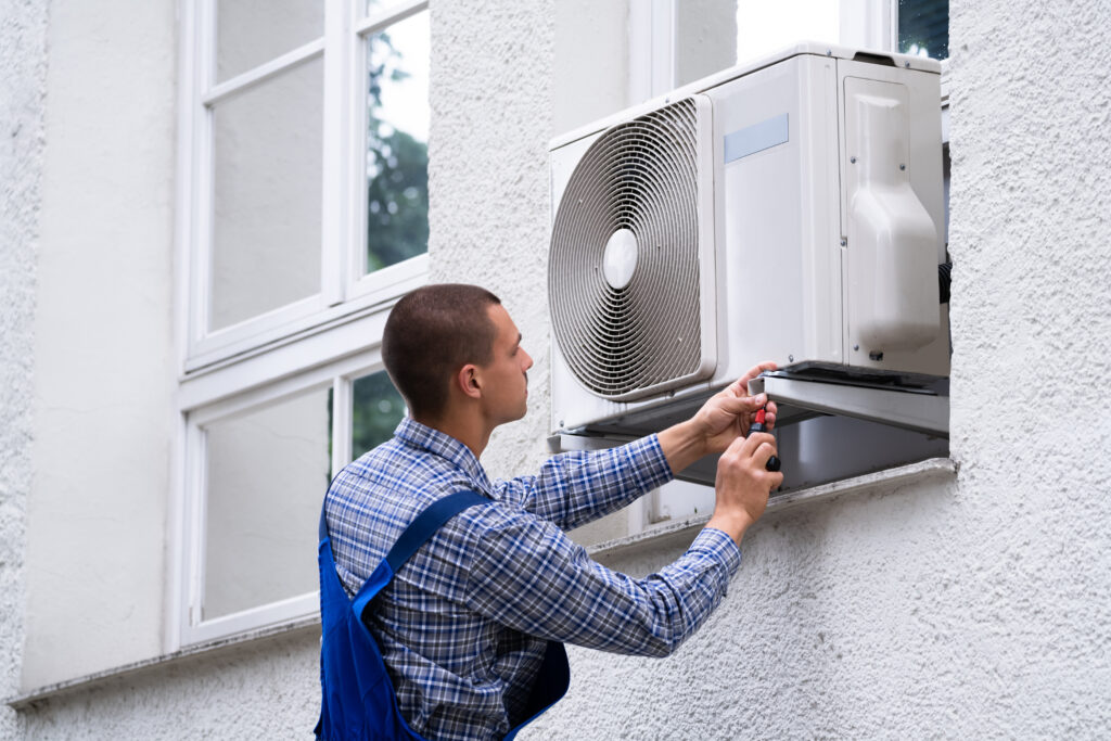 technician,cleaning,and,repairing,air,condition,appliance.,ac,unit,maintenance