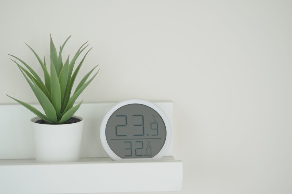 a,sleek,digital,clock,displays,temperature,and,humidity,beside,a