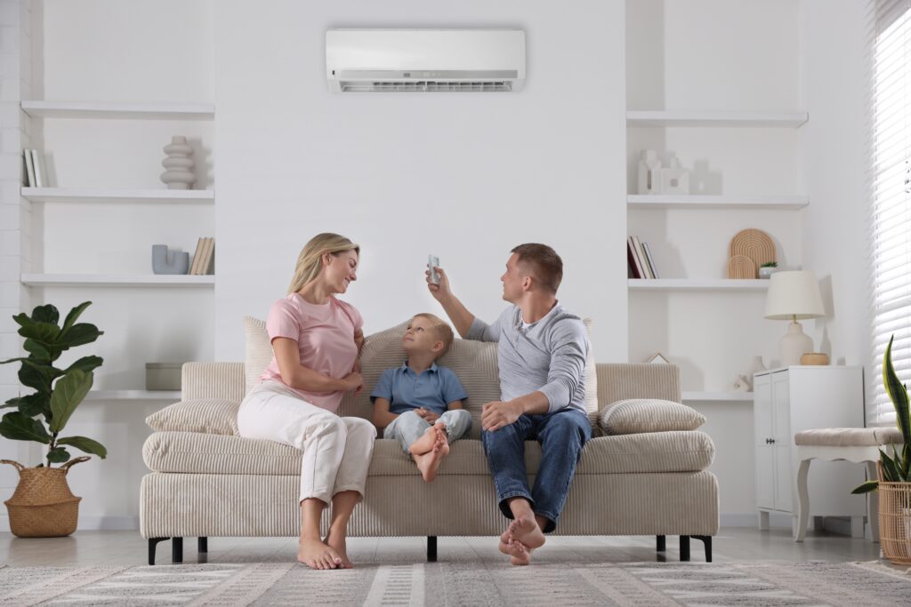family,resting,together,on,sofa,at,home.,man,switching,on